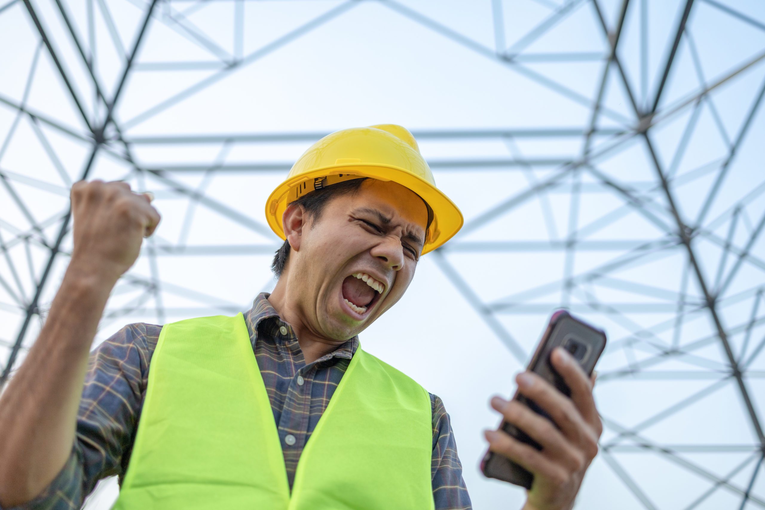 Portrait of young asian electrician use smart phone in the workplace